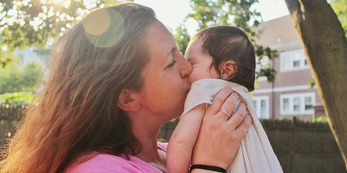 Woman kissing infant