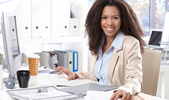 young woman works at computer