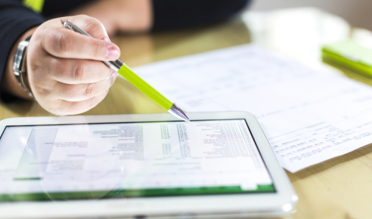 person looks at reimbursement report on tablet