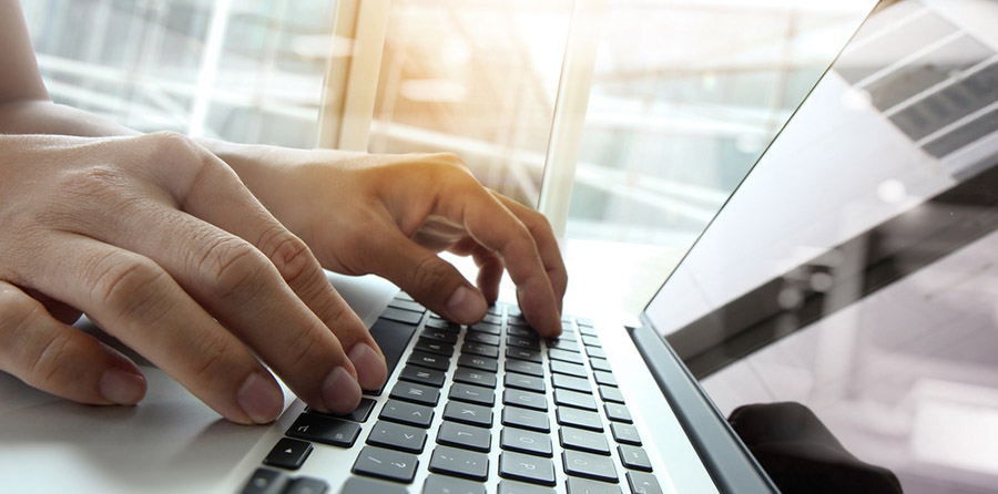 Hands on laptop keyboard