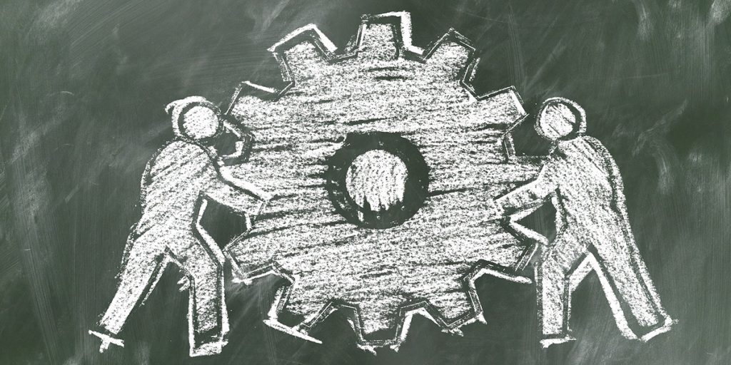 Chalk rendering of two people with a gear