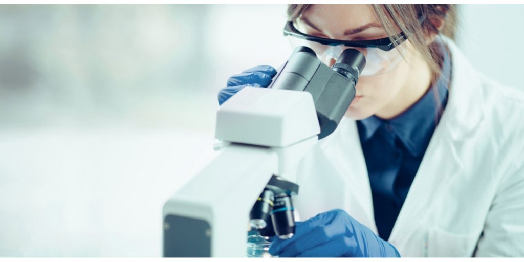 Female lab tech looking in microscope