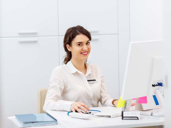smiling registration clerk in healthcare setting